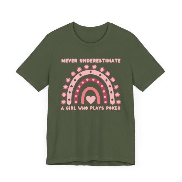 A military green colored Bella+Canvas 3001 T-shirt featuring a boho rainbow graphic in shades of pink. The graphic incorporates elements of the game of poker, such as card suits and poker chips. The text in the design says "Never underestimate a girl who plays poker".