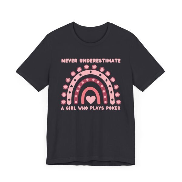 A dark grey colored Bella+Canvas 3001 T-shirt featuring a boho rainbow graphic in shades of pink. The graphic incorporates elements of the game of poker, such as card suits and poker chips. The text in the design says "Never underestimate a girl who plays poker".