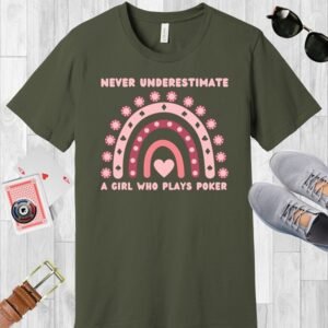 An army colored Bella+Canvas 3001 T-shirt featuring a boho rainbow graphic in shades of pink. The graphic incorporates elements of the game of poker, such as card suits and poker chips. The text in the design says "Never underestimate a girl who plays poker".