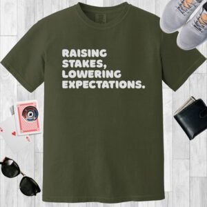 Moss colored Comfort Colors crewneck T-shirt. Features a poker-themed text design 'Raising stakes, lowering expectations'.