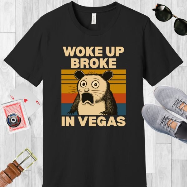 Black colored Bella+Canvas crewneck poker-themed T-shirt. Design features a shocked possum and the text 'Woke up broke in Vegas'.