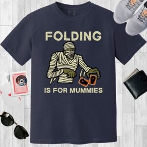 Navy colored unisex crewneck poker-themed T-shirt. Design features the text 'Folding is for mummies'. A mummy folding a pair of cards.