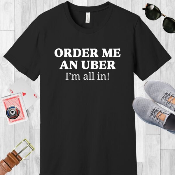 Black colored Bella+Canvas crewneck poker-themed T-shirt. Design features the text 'Order me an Uber, I'm all in!'.