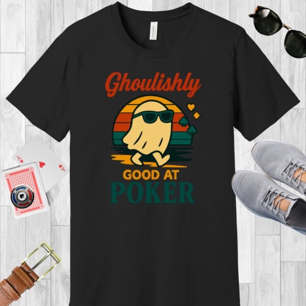 Black colored Bella+Canvas crewneck poker-themed T-shirt. Design features the multi-colored text 'Ghoulishly good at poker'. There's an image of a sunglass-wearing ghost in front of a vintage sunset.