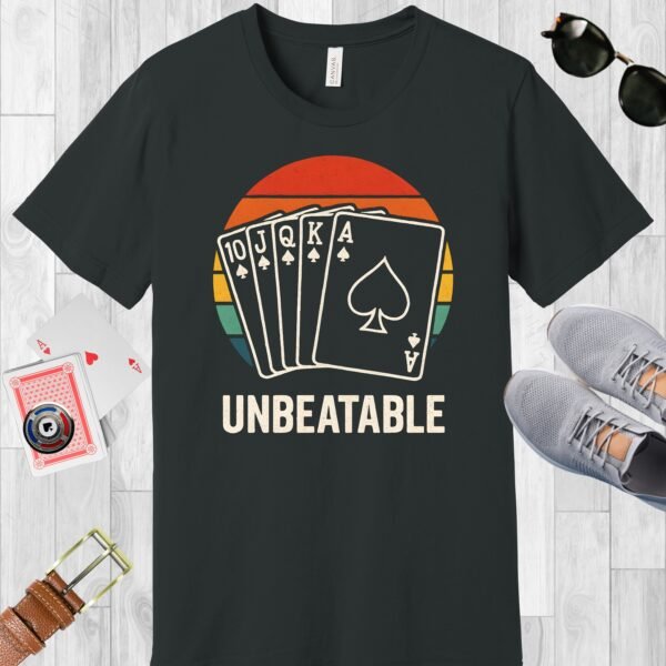 Dark Grey colored Bella+Canvas crewneck poker-themed T-shirt. Design features a vintage sunset overlaid with a royal flush, and the text 'Unbeatable'.
