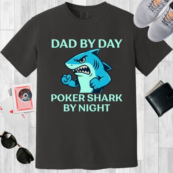 Graphite colored Comfort Colors crewneck poker-themed T-shirt. Design features the text 'Dad by day Poker Shark by night' along with an image of an intimidating shark.