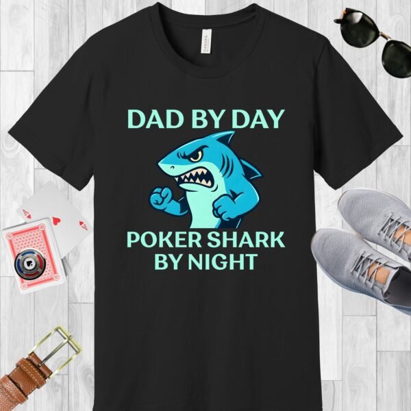 Black colored Bella+Canvas crewneck poker-themed T-shirt. Design features the text 'Dad by day Poker Shark by night' along with an image of an intimidating shark.