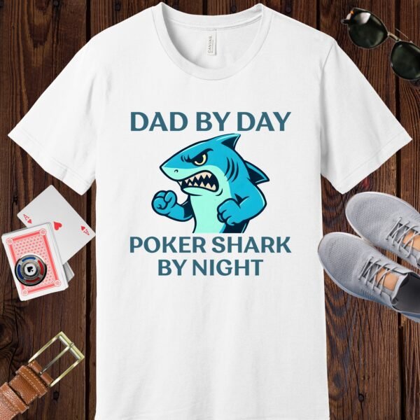 White colored Bella+Canvas crewneck poker-themed T-shirt. Design features the text 'Dad by day Poker Shark by night' along with an image of an intimidating shark.