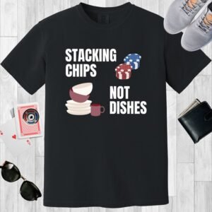Black colored Comfort Colors crewneck poker-themed T-shirt. Design features the text 'Stacking chips not dishes' along with images of poker chip stacks and piled dishes.
