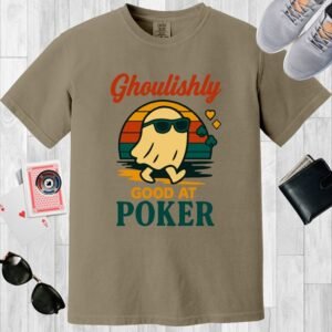 Khaki colored Comfort Colors crewneck poker-themed T-shirt. Design features the multi-colored text 'Ghoulishly good at poker'. There's an image of a sunglass-wearing ghost in front of a vintage sunset.