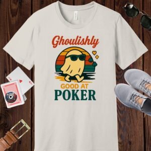 Vintage White colored Bella+Canvas crewneck poker-themed T-shirt. Design features the multi-colored text 'Ghoulishly good at poker'. There's an image of a sunglass-wearing ghost in front of a vintage sunset.