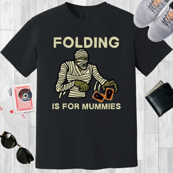 Black colored unisex crewneck poker-themed T-shirt. Design features the text 'Folding is for mummies'. A mummy folding a pair of cards.