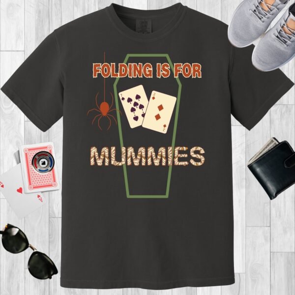 Graphite colored unisex crewneck poker-themed T-shirt. Design features the text 'Folding is for mummies'. There's a spider, a coffin outline, and the playing cards 7 and 2.