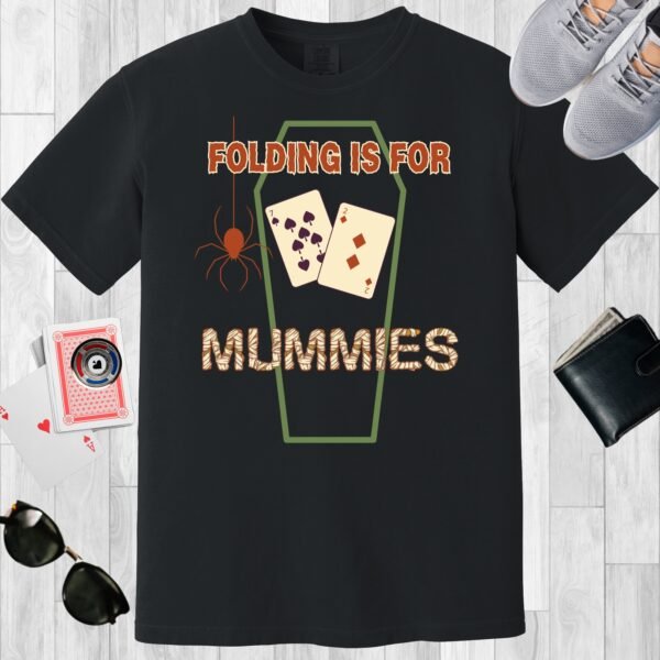 Black colored unisex crewneck poker-themed T-shirt. Design features the text 'Folding is for mummies'. There's a spider, a coffin outline, and the playing cards 7 and 2.