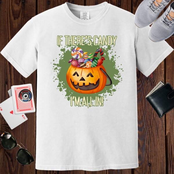 White colored unisex crewneck poker-themed T-shirt. Design features the text 'If there's candy, I'm all in'. An image of a Jack-o-lantern filled with candy.