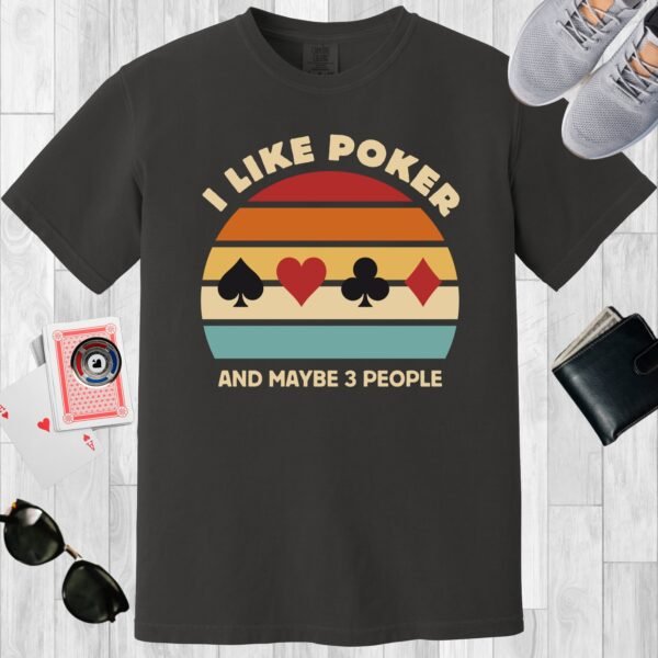 Black colored unisex crewneck poker-themed T-shirt. Design features the text 'I like poker and maybe 3 people'. Vintage sunset design with card suits.