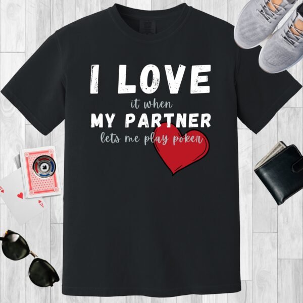 Black colored unisex crewneck poker-themed T-shirt. Design features the text 'I love it when my partner lets me play poker'.