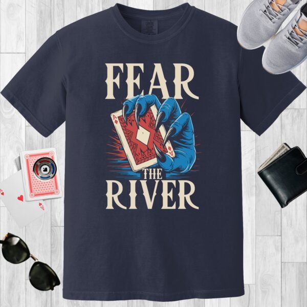 Navy colored unisex crewneck poker-themed T-shirt. Design features the text 'Fear the river'. Image of a blue monster claw/hand holding an Ace playing card.
