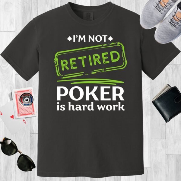 Graphite colored unisex crewneck poker-themed T-shirt. Design features the text 'I'm not retired. Poker is hard work'.