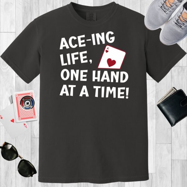 Graphite colored unisex crewneck poker-themed T-shirt. Design features the text 'Ace-ing life. One hand at a time!' An image of the Ace of hearts.