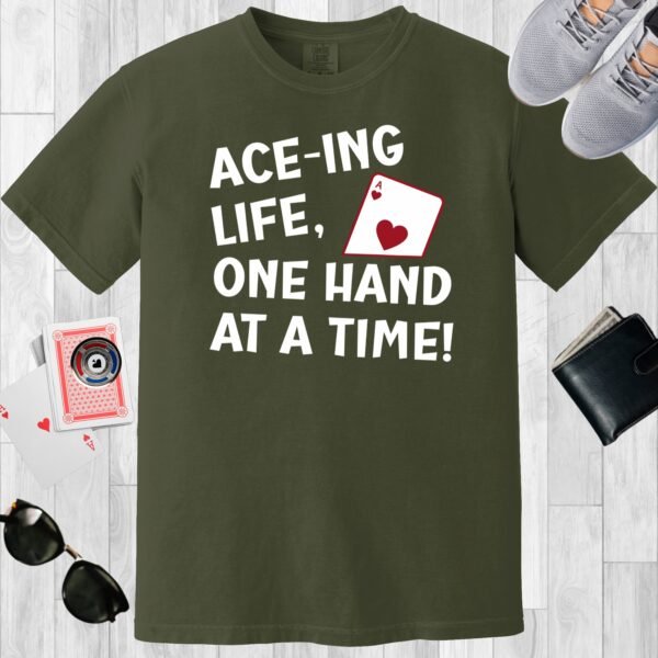 Moss colored unisex crewneck poker-themed T-shirt. Design features the text 'Ace-ing life. One hand at a time!' An image of the Ace of hearts.