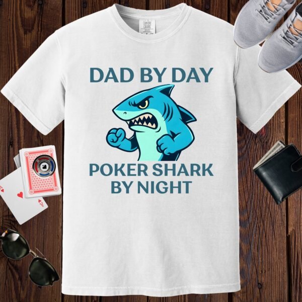 White colored unisex crewneck poker-themed T-shirt. Design features the text 'Dad by day, poker shark by night'. Image of an aggressive shark.