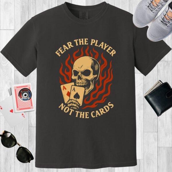 Graphite colored unisex crewneck poker-themed T-shirt. Design features the text 'Fear the player not the cards'. Skull with Aces on a flame background.
