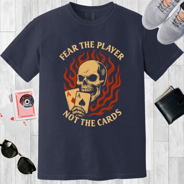 Navy colored unisex crewneck poker-themed T-shirt. Design features the text 'Fear the player not the cards'. Skull with Aces on a flame background.
