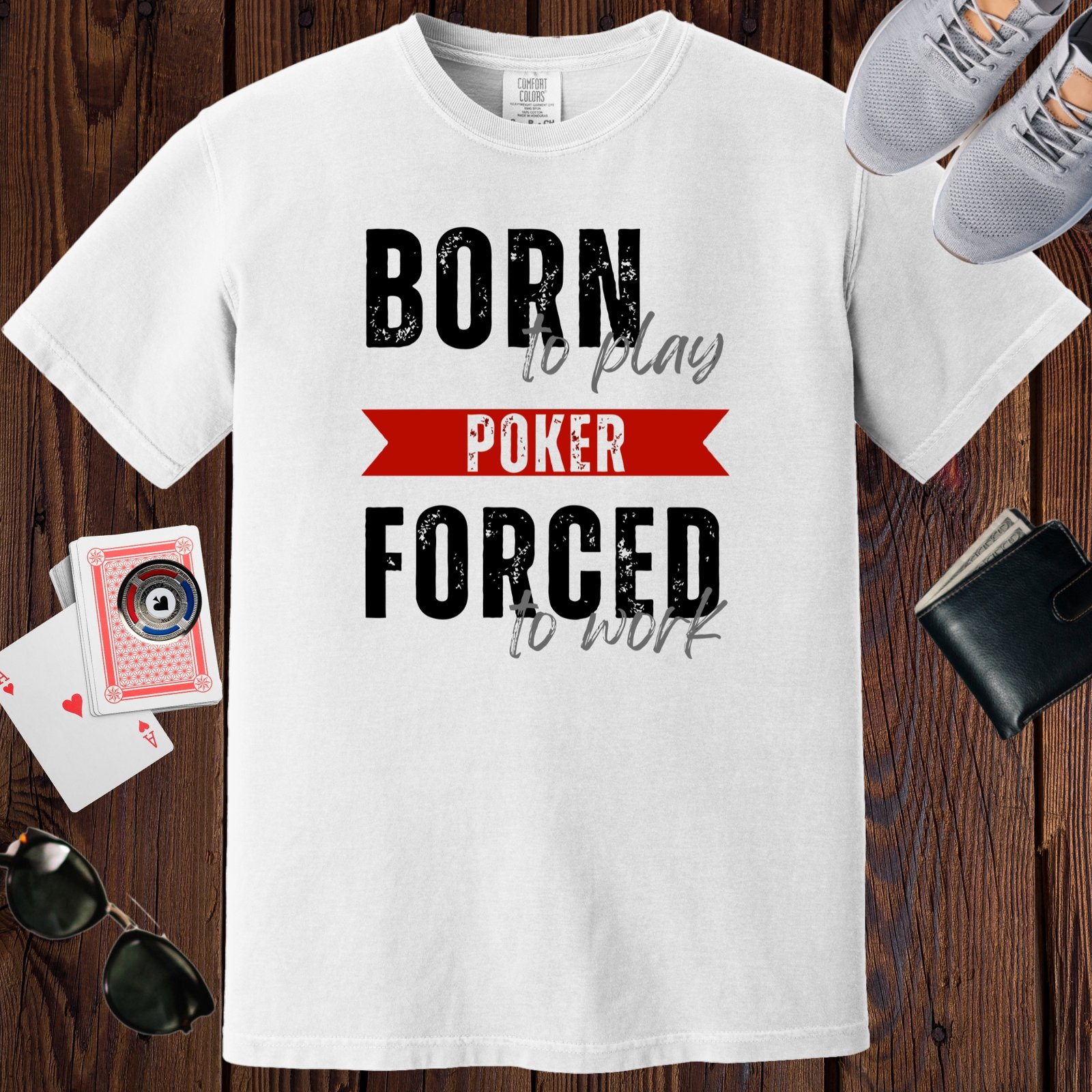 White colored unisex crewneck poker-themed T-shirt. Design features the text 'Born to play poker, forced to work.'