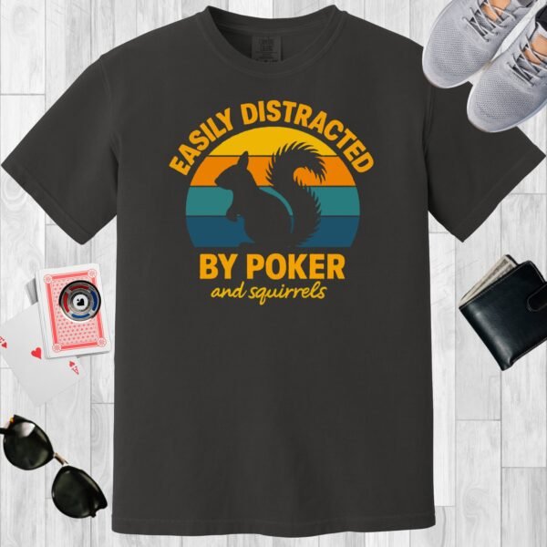 Graphite colored unisex crewneck poker-themed T-shirt. Design features the text 'Easily distracted by poker and squirrels'. A squirrel on a retro sunset background.