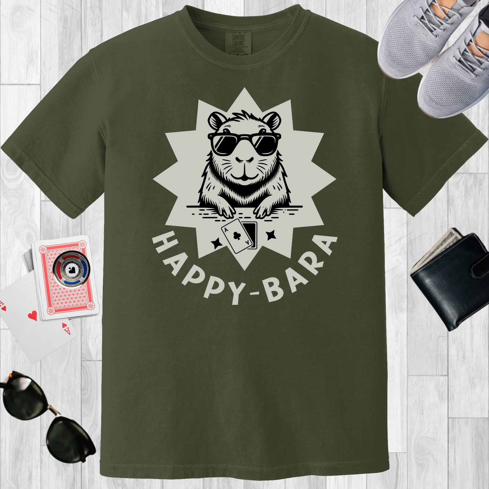 Moss colored unisex crewneck poker-themed T-shirt. Design features the text 'Happy-bara'. An image of a sunglass-wearing capybara with playing cards on a starburst background.