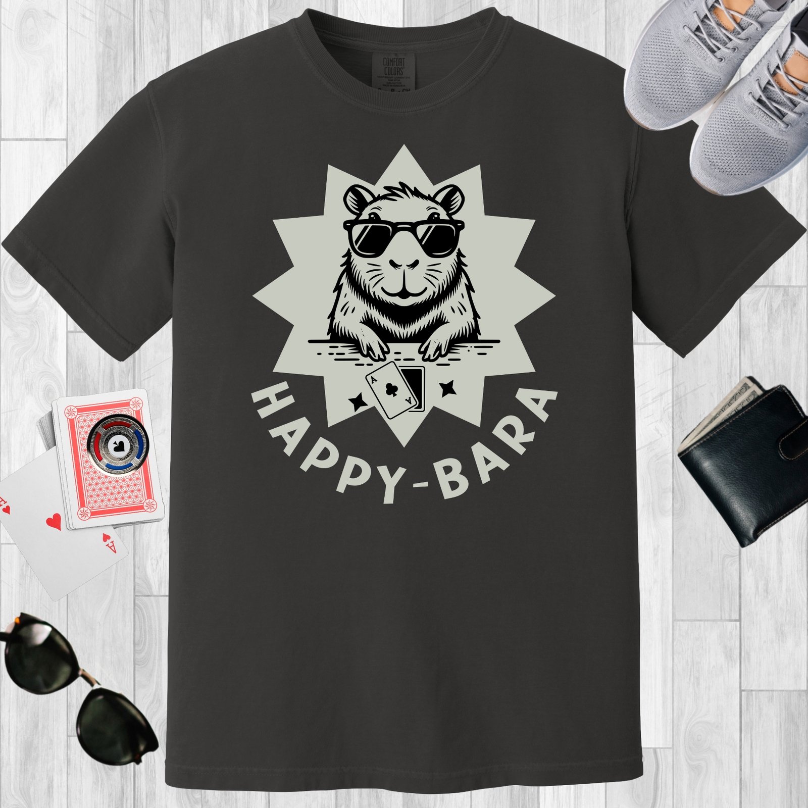 Graphite colored unisex crewneck poker-themed T-shirt. Design features the text 'Happy-bara'. An image of a sunglass-wearing capybara with playing cards on a starburst background.