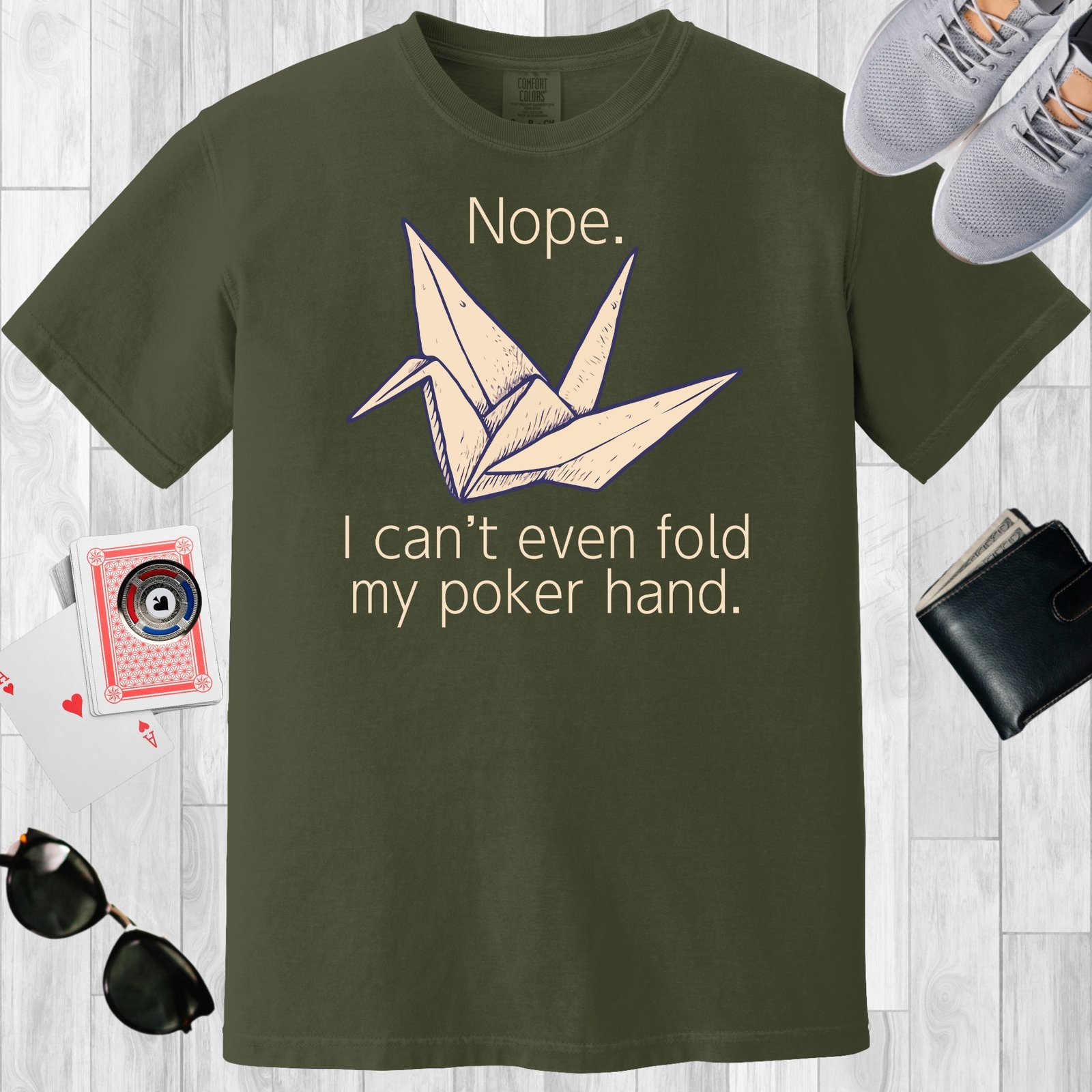 Moss colored unisex crewneck poker-themed T-shirt. Design features the text 'Nope. I can't even fold my poker hand.' An image of an origami paper crane.