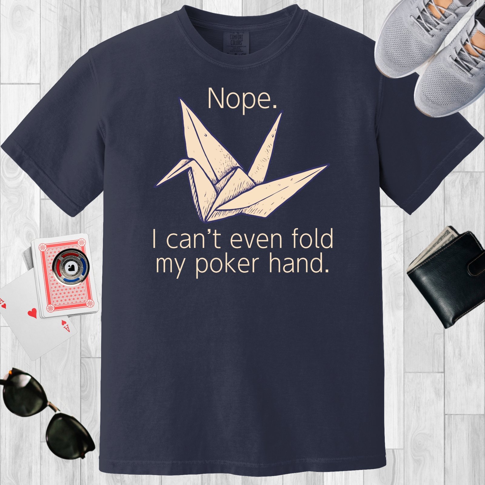 Navy colored unisex crewneck poker-themed T-shirt. Design features the text 'Nope. I can't even fold my poker hand.' An image of an origami paper crane.