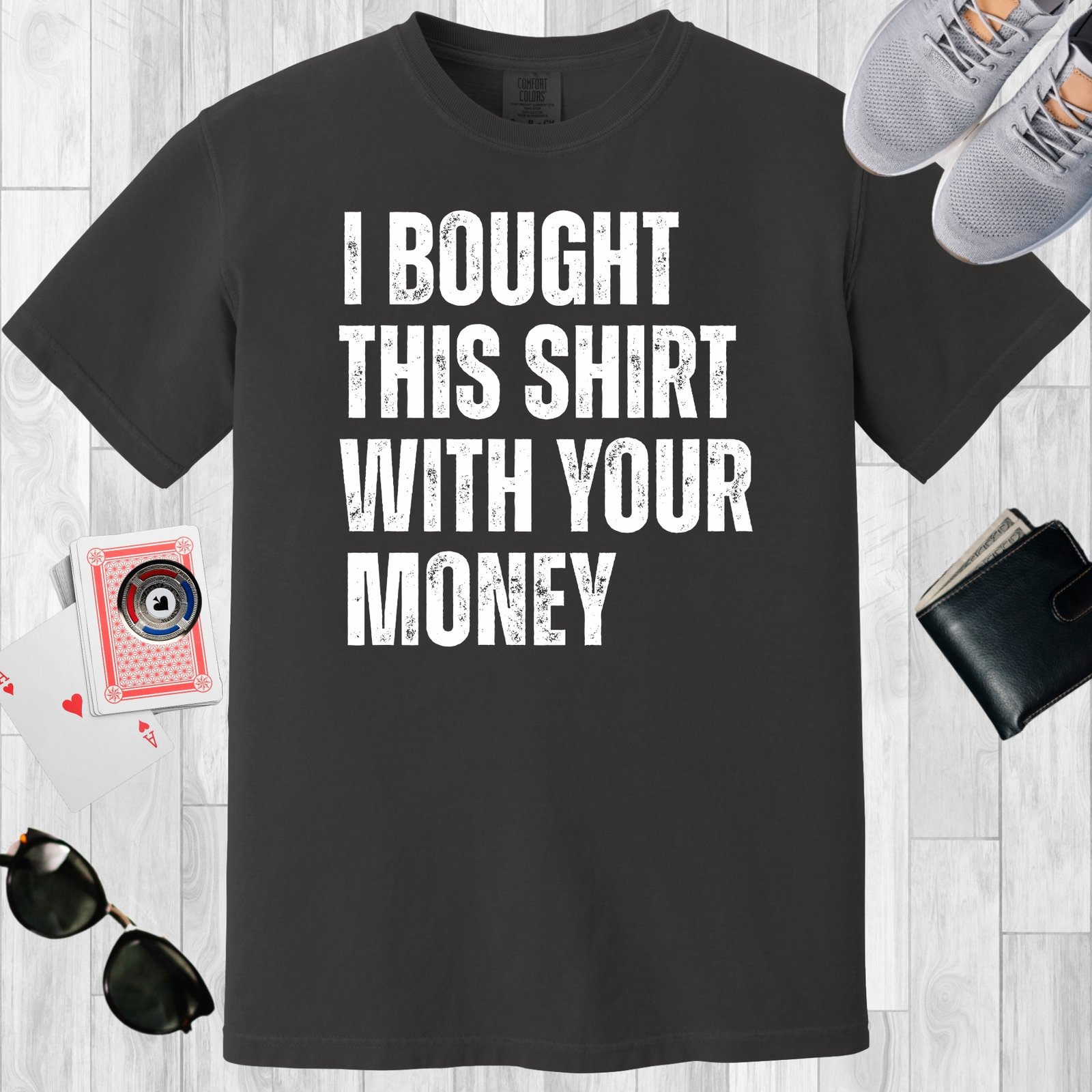 Graphite colored unisex crewneck poker-themed T-shirt. Design features the text 'I bought this shirt with your money'.