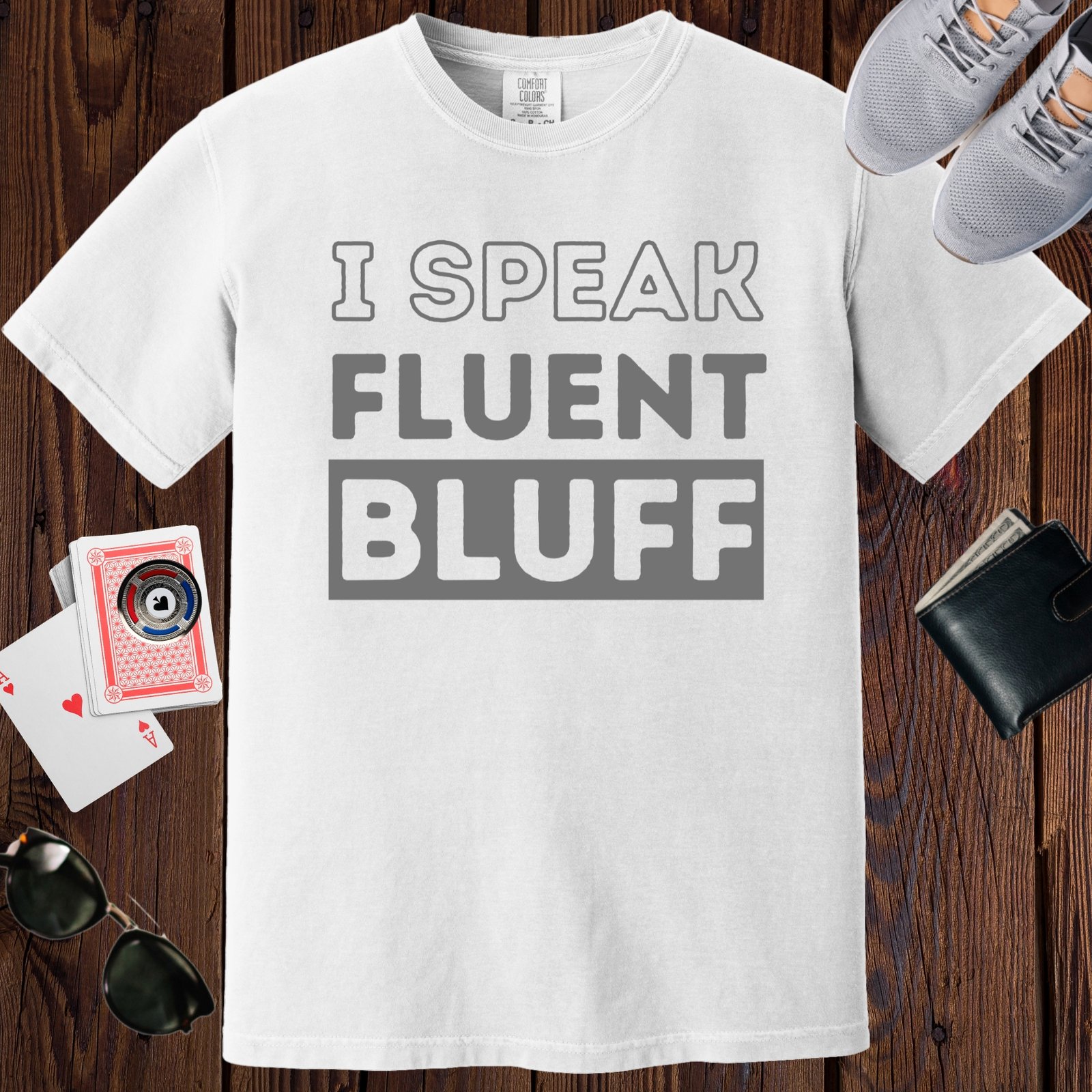White colored unisex crewneck poker-themed T-shirt. Design features the text 'I speak fluent bluff'.