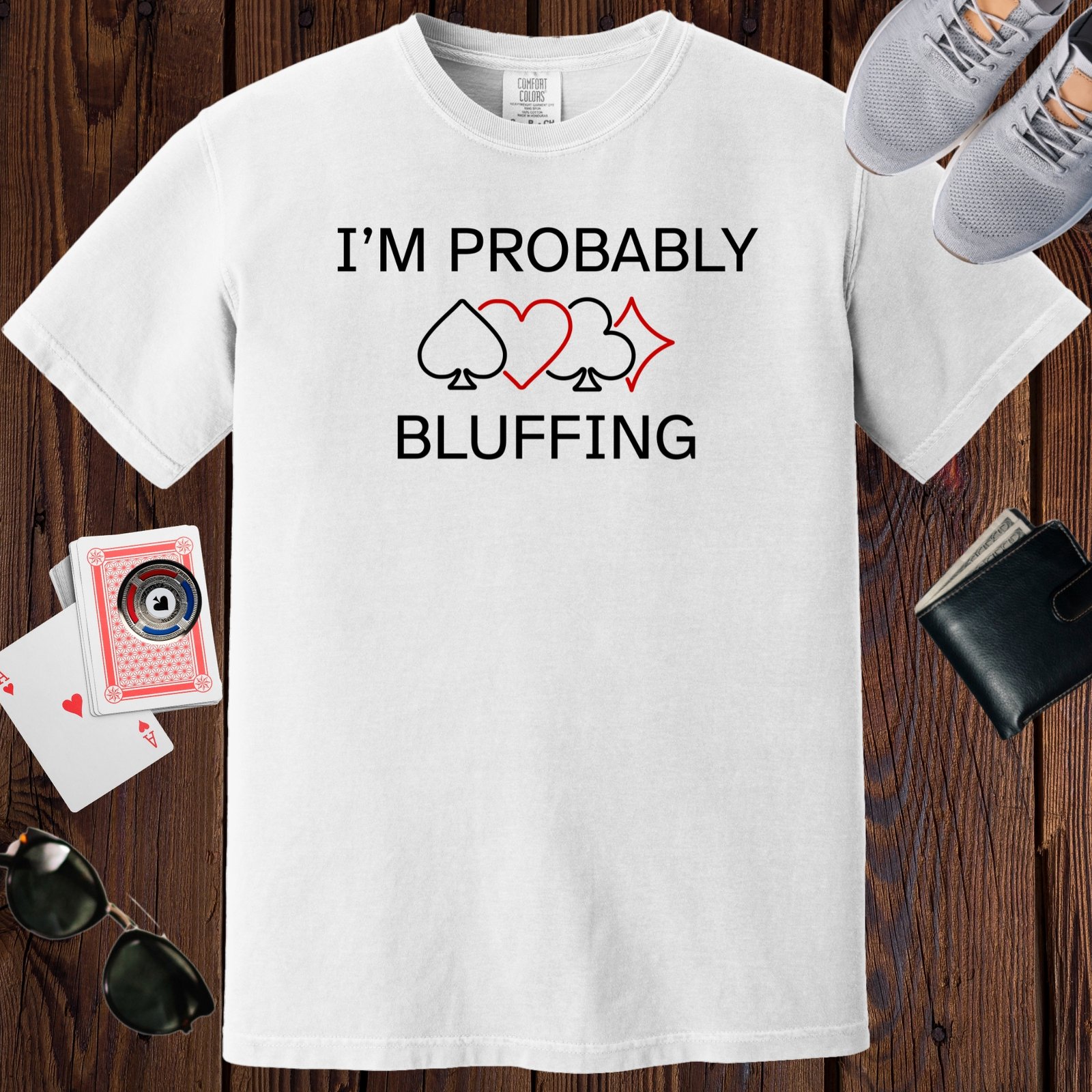 White colored unisex crewneck poker-themed T-shirt. Design features line art of card suits and the text 'I'm probably bluffing'.