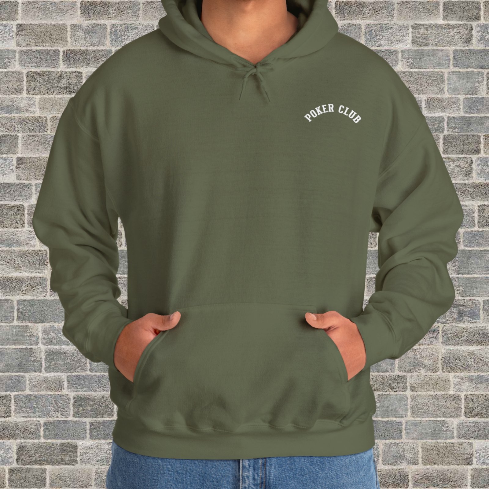 Person wearing a military green poker-themed Gildan hooded sweatshirt with the small left chest text "Poker Club" in front of a brick wall.