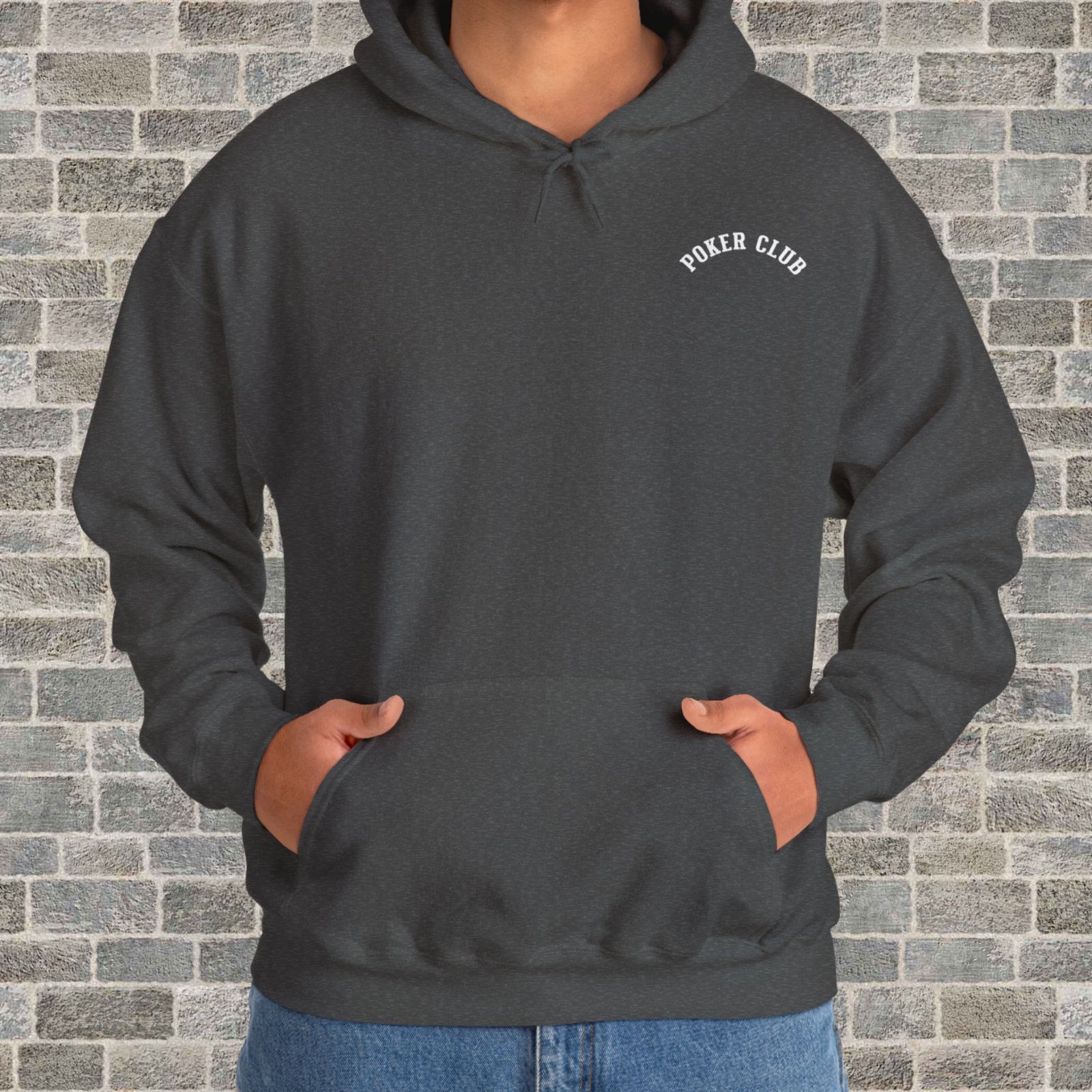 Person wearing a dark heather poker-themed Gildan hooded sweatshirt with the small left chest text "Poker Club" in front of a brick wall.
