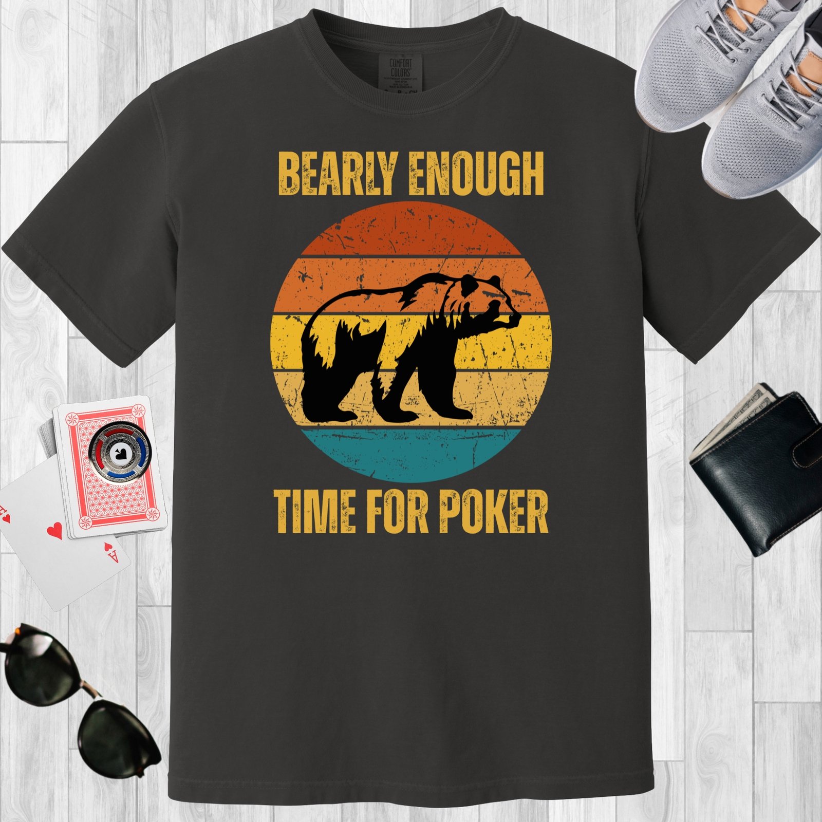 Graphite colored unisex crewneck poker-themed T-shirt. Design features the text 'Bearly enough time for poker'. Image of a grizzly bear on a retro sunset background.