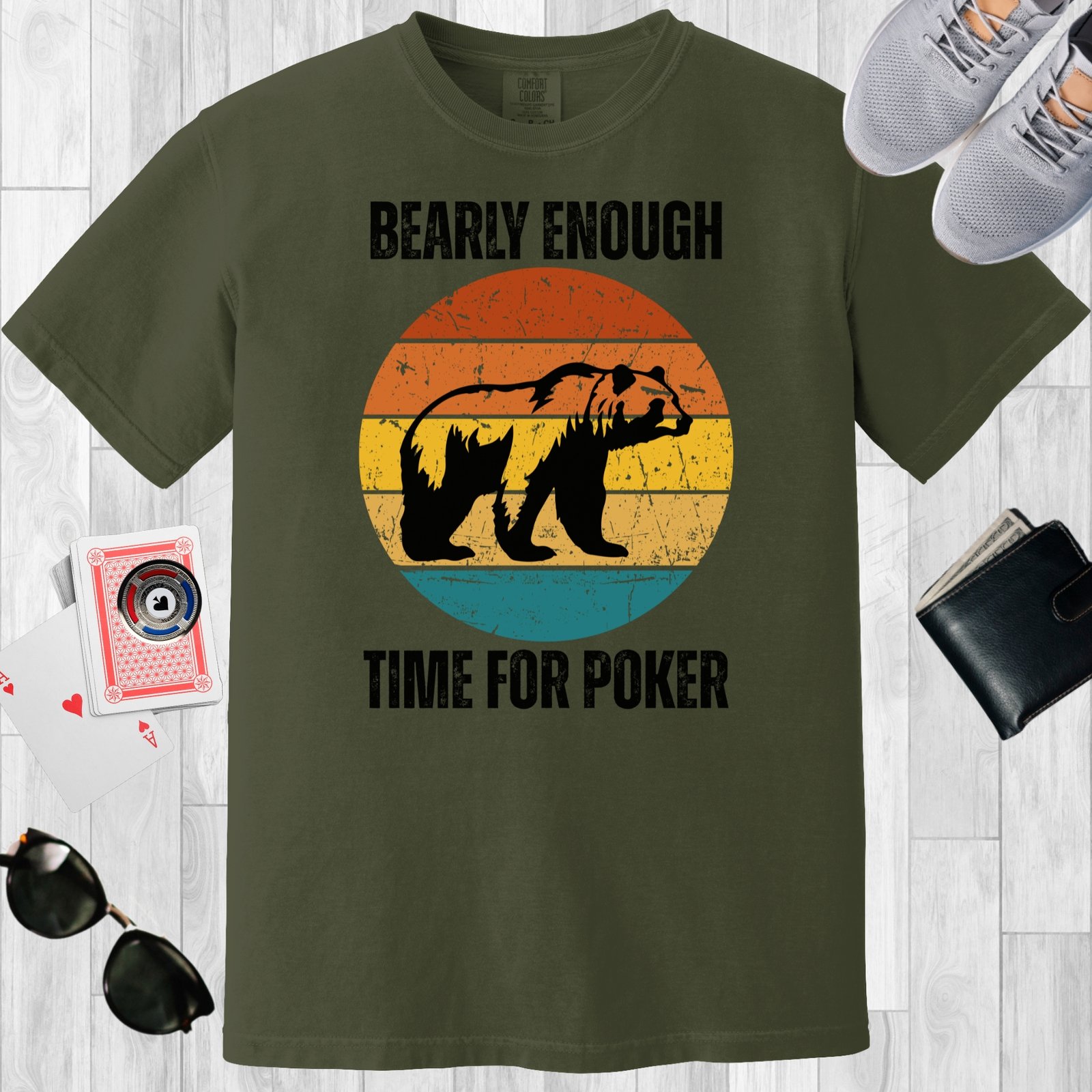 Moss colored unisex crewneck poker-themed T-shirt. Design features the text 'Bearly enough time for poker'. Image of a grizzly bear on a retro sunset background.
