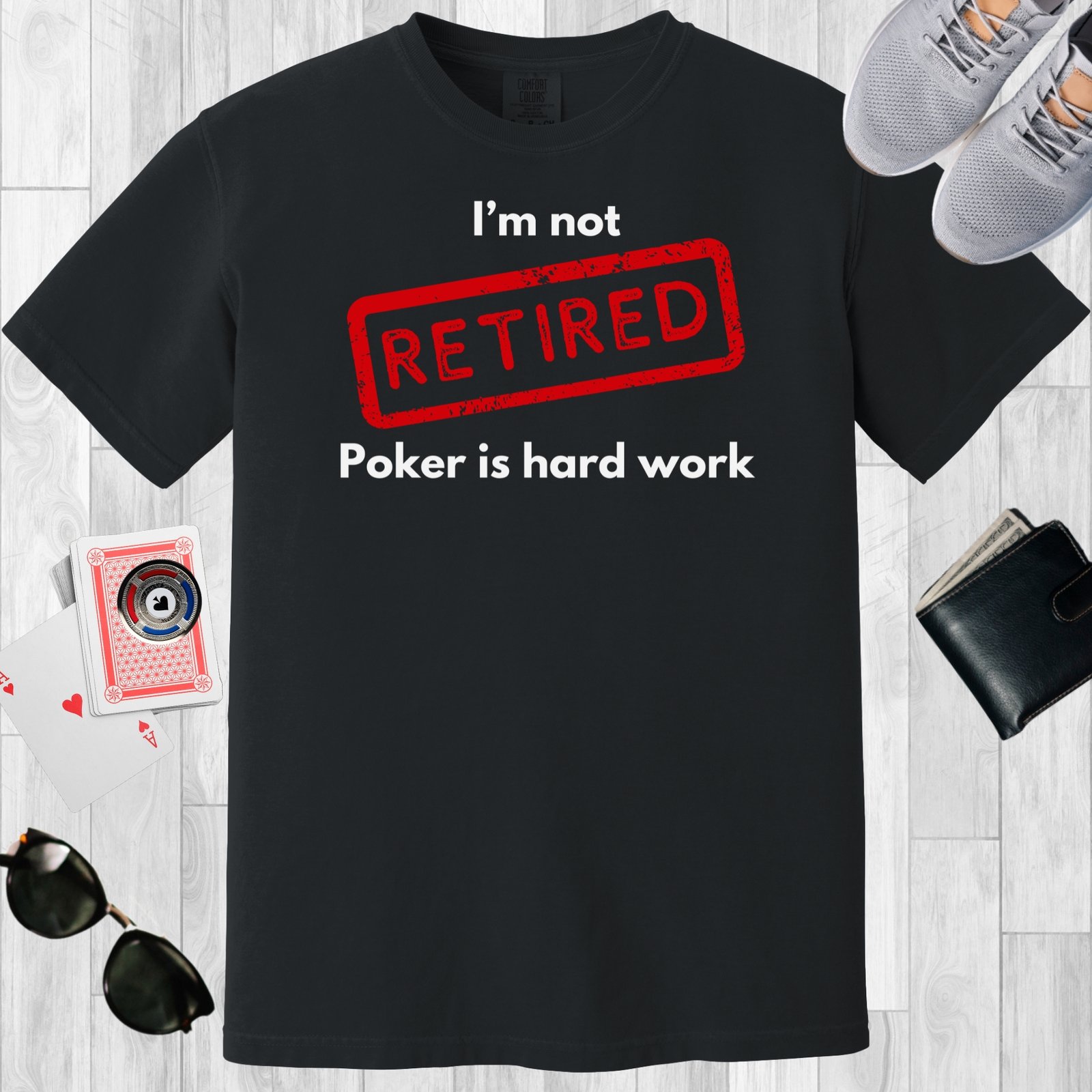 Black colored unisex crewneck poker-themed T-shirt. Design features the text 'I'm not retired, poker is hard work'.