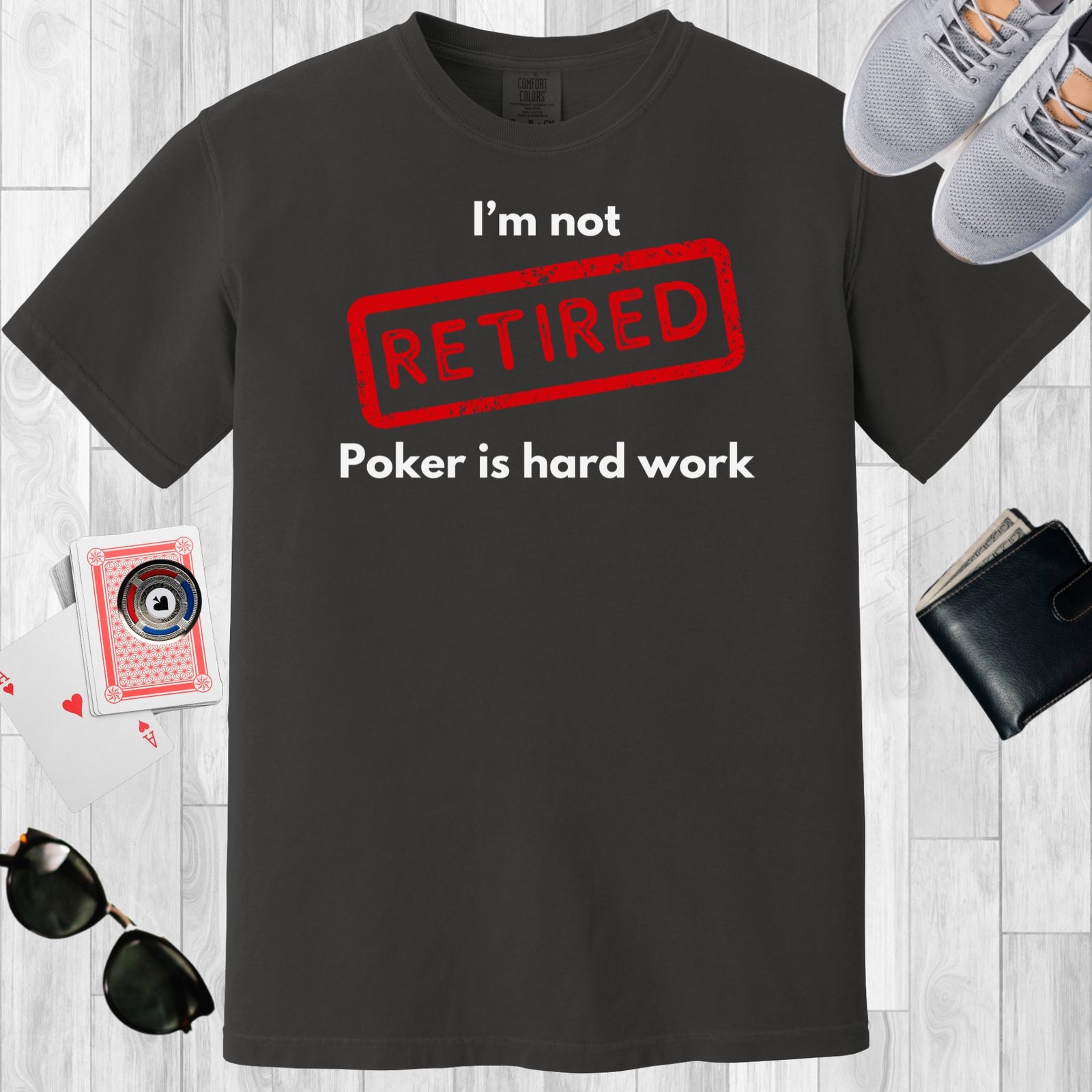 Graphite colored unisex crewneck poker-themed T-shirt. Design features the text 'I'm not retired, poker is hard work'.
