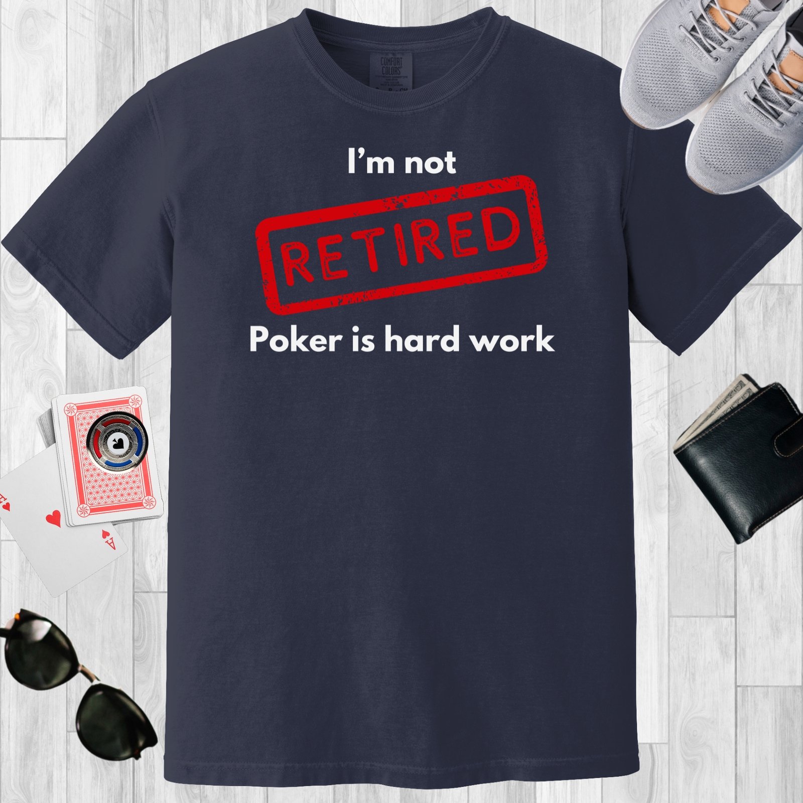 Navy colored unisex crewneck poker-themed T-shirt. Design features the text 'I'm not retired, poker is hard work'.