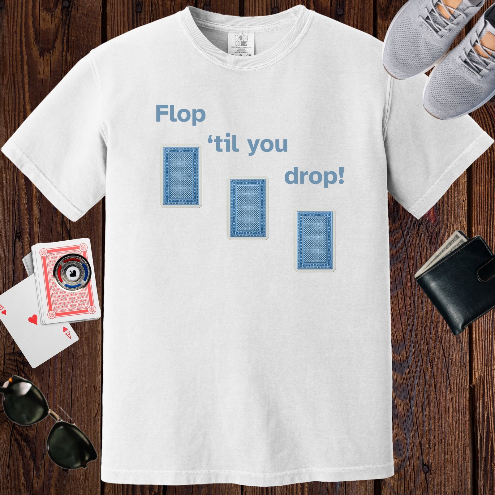 White colored unisex crewneck poker-themed T-shirt. Design features the text 'Flop 'til you drop'. Image of 3 playing cards face down.
