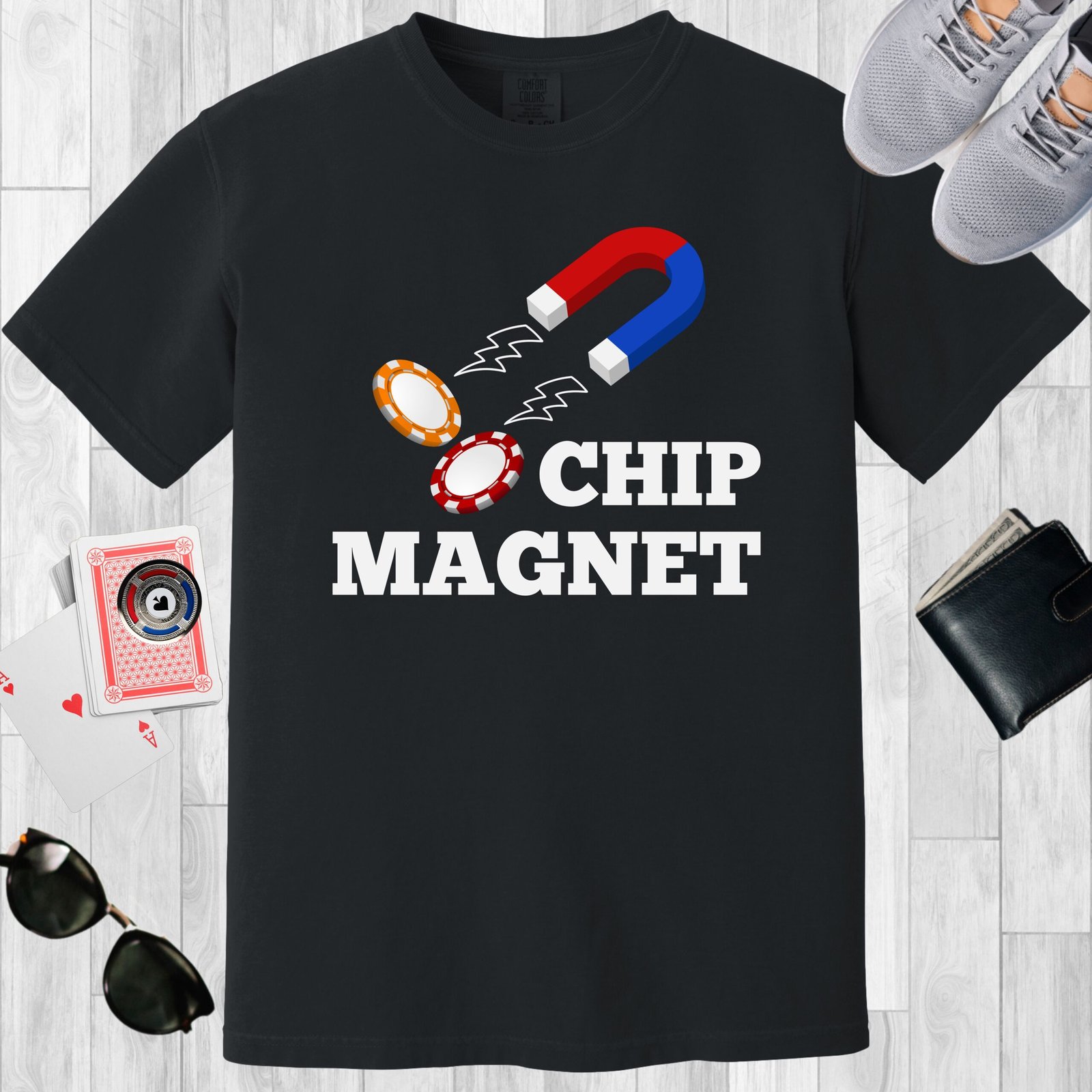 Black colored unisex crewneck poker-themed T-shirt. Design features the text 'Chip Magnet' Image of a magnet attracting poker chips.