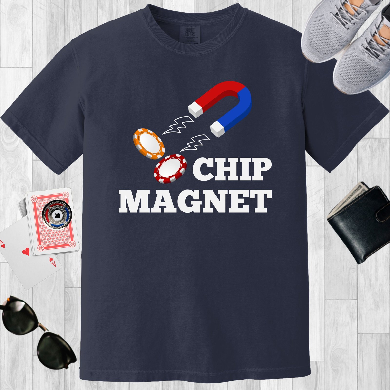 Navy colored unisex crewneck poker-themed T-shirt. Design features the text 'Chip Magnet' Image of a magnet attracting poker chips.
