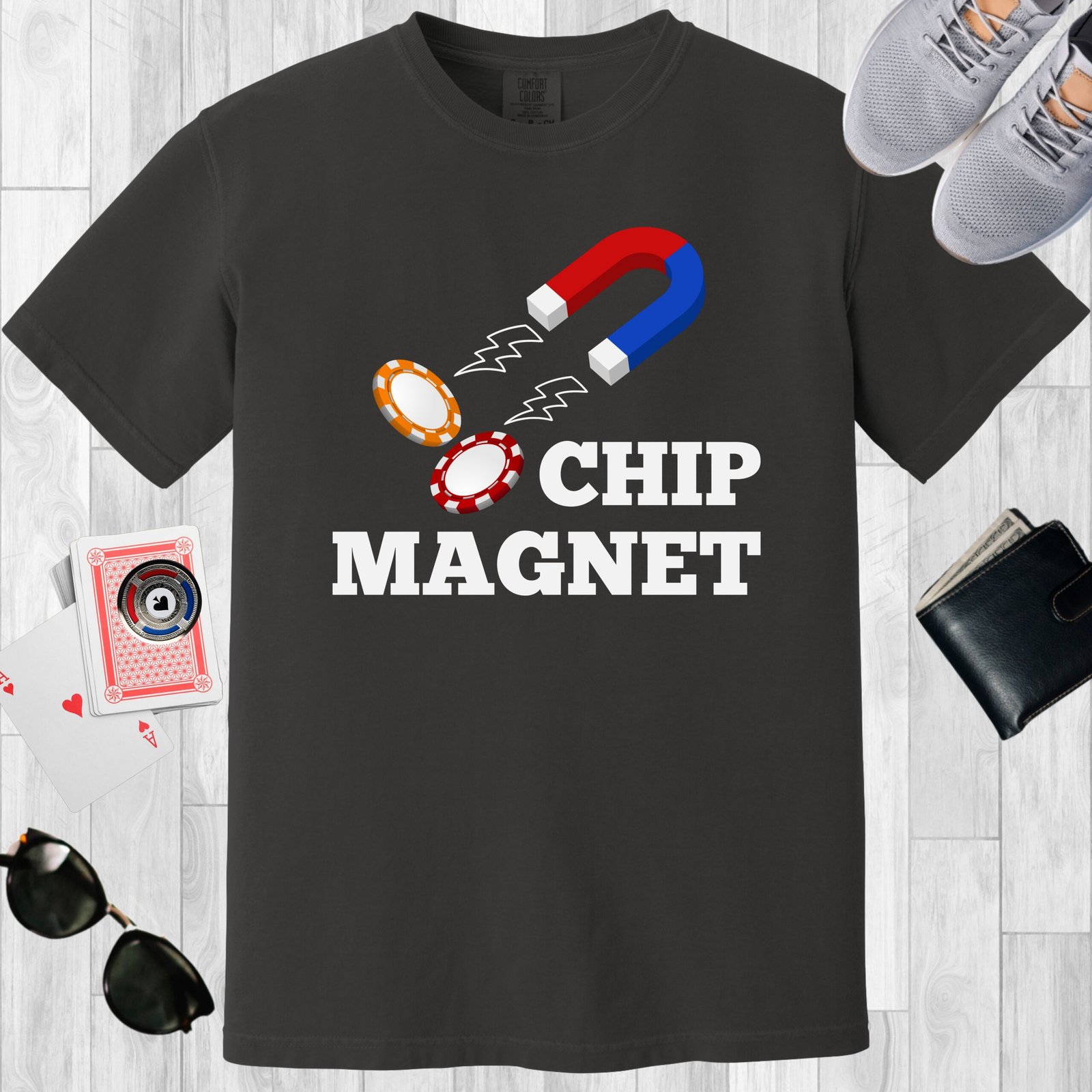 Graphite colored unisex crewneck poker-themed T-shirt. Design features the text 'Chip Magnet' Image of a magnet attracting poker chips.
