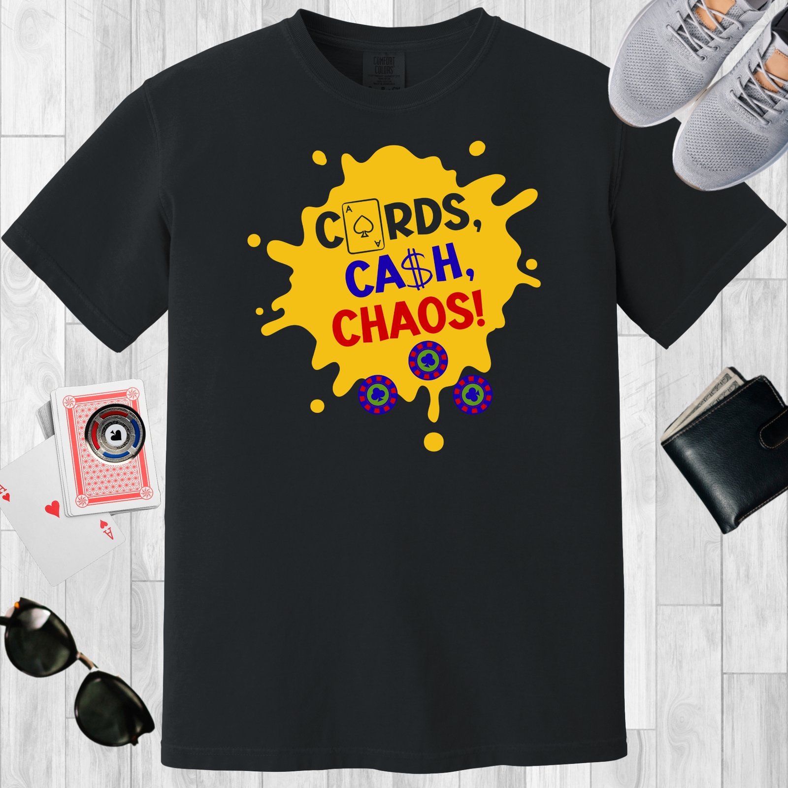 Black colored unisex crewneck poker-themed T-shirt. Design features the text 'Cards, Cash, Choas'. The text and a few poker chips are positioned over a yellow paint splotch.