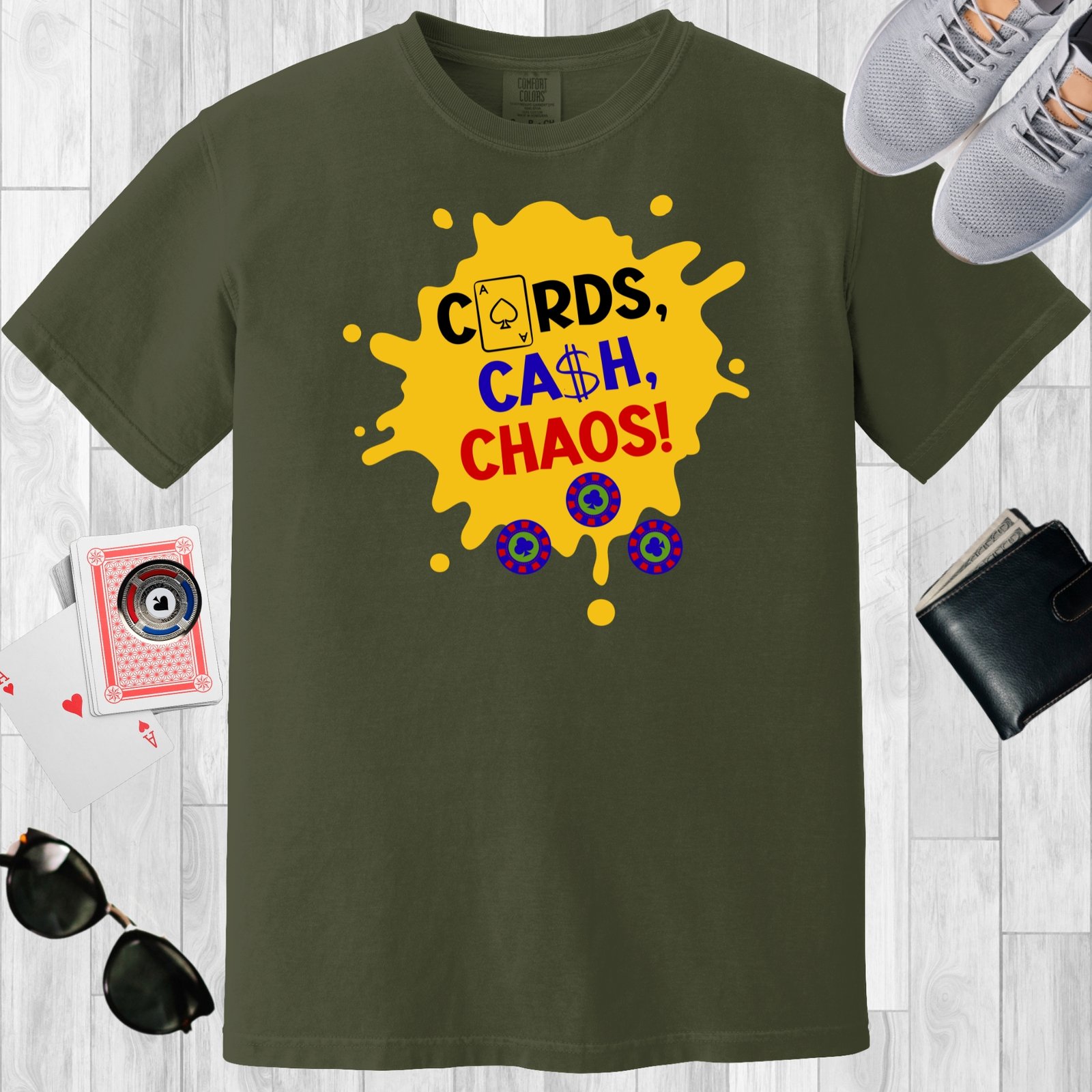 Moss colored unisex crewneck poker-themed T-shirt. Design features the text 'Cards, Cash, Choas'. The text and a few poker chips are positioned over a yellow paint splotch.